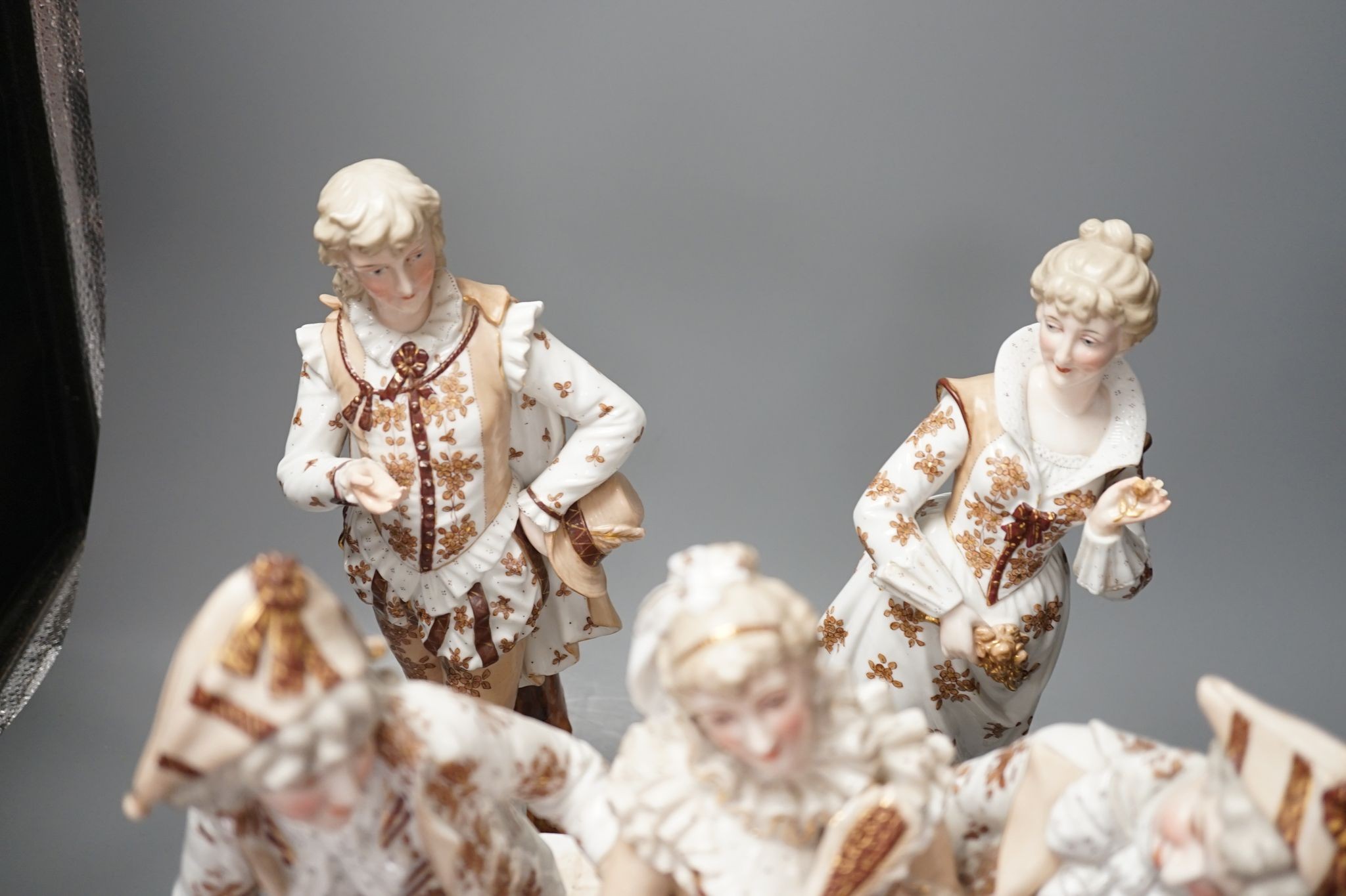 A pair of large French porcelain figures, 38cm, and a figural group en suite